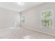 This empty bedroom features two windows, carpeted floors, and neutral decor at 1100 Dotson Way, Apex, NC 27523