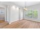 Bright dining room featuring recessed lighting, a modern chandelier, and lots of natural light at 1100 Dotson Way, Apex, NC 27523