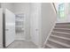 Entryway with a carpeted staircase, light walls, and an open doorway to a room with drywall at 1100 Dotson Way, Apex, NC 27523