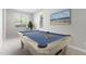 Virtual staging highlights this game room with a pool table and seaside painting at 1100 Dotson Way, Apex, NC 27523