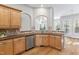 Kitchen with wood cabinets, stainless steel appliances, and wood floors at 1100 Dotson Way, Apex, NC 27523