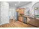 Spacious kitchen featuring stainless steel appliances, wood cabinets, and granite countertops at 1100 Dotson Way, Apex, NC 27523