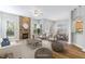 Bright living room with a stone fireplace, hardwood floors, and lots of natural light at 1100 Dotson Way, Apex, NC 27523