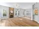 View of a living room with a stone fireplace and open floor plan with natural light at 1100 Dotson Way, Apex, NC 27523