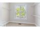 Walk-in closet boasts shelving and bright window view at 1100 Dotson Way, Apex, NC 27523