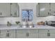 Kitchen with stainless steel sink with stylish faucet fixtures and natural light from window at 113 Ellen Pl, Chapel Hill, NC 27514