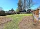 Large, green backyard with a wooden fence, perfect for outdoor activities at 117 Woodcroft Drive Dr, Angier, NC 27501