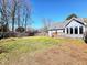 Spacious backyard with a well-maintained lawn and a view of the home's exterior at 117 Woodcroft Drive Dr, Angier, NC 27501