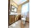 Bathroom featuring a wood vanity, decorative mirror and natural light at 117 Woodcroft Drive Dr, Angier, NC 27501