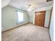 Upstairs bedroom with two closets, blue walls, neutral carpet, and a ceiling fan at 117 Woodcroft Drive Dr, Angier, NC 27501