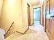 Well-lit hallway with carpet flooring and wooden doors leading to bedrooms at 117 Woodcroft Drive Dr, Angier, NC 27501