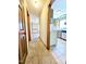 Hallway view towards kitchen and dining room, featuring hardwood floors and neutral paint at 117 Woodcroft Drive Dr, Angier, NC 27501