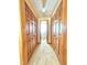 Hallway with wood closet doors, neutral carpet and view of the bathroom at the end at 117 Woodcroft Drive Dr, Angier, NC 27501