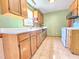 Functional kitchen with light oak cabinets, white countertops, and ample storage space at 117 Woodcroft Drive Dr, Angier, NC 27501