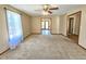 Bright living room with neutral carpet, large window and open layout to adjoining room at 117 Woodcroft Drive Dr, Angier, NC 27501