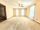 Spacious living room with neutral carpet, ceiling fan, and lots of natural light at 117 Woodcroft Drive Dr, Angier, NC 27501