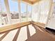 Sunny sunroom featuring tile floors, large windows, and backyard views at 117 Woodcroft Drive Dr, Angier, NC 27501