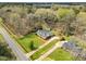 Aerial view showcasing the home, shed, landscaping, and driveway at 1192 Princeton Kenly Rd, Kenly, NC 27542