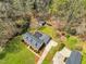 Aerial view of the property with the home, shed, driveway, mature trees and landscaping at 1192 Princeton Kenly Rd, Kenly, NC 27542