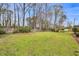 Expansive backyard featuring a well-maintained lawn, mature trees, and partial fencing at 1192 Princeton Kenly Rd, Kenly, NC 27542