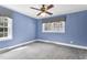 Blue bedroom with ceiling fan and two windows at 1192 Princeton Kenly Rd, Kenly, NC 27542