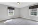 Neutral bedroom with two windows and carpeting at 1192 Princeton Kenly Rd, Kenly, NC 27542