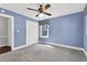 Blue bedroom featuring closet, window, and ceiling fan at 1192 Princeton Kenly Rd, Kenly, NC 27542