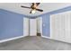 Blue bedroom with closet, window, and doorway at 1192 Princeton Kenly Rd, Kenly, NC 27542