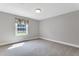 Neutral bedroom with window with bright natural light and light carpeting at 1192 Princeton Kenly Rd, Kenly, NC 27542