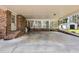 Covered carport with brick flooring, leading to a sunroom and additional outdoor structures at 1192 Princeton Kenly Rd, Kenly, NC 27542