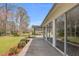 View of a deck with an attached sunroom, leading to a garden and open backyard space at 1192 Princeton Kenly Rd, Kenly, NC 27542