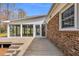 Exterior view of a wooden deck leading to a sunroom, showcasing the transition between indoor and outdoor living spaces at 1192 Princeton Kenly Rd, Kenly, NC 27542