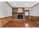 Cozy fireplace with brick surround and wood mantel, complemented by wood paneling at 1192 Princeton Kenly Rd, Kenly, NC 27542