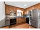 Well-lit kitchen featuring wood cabinets, stainless steel appliances, and granite countertops at 1192 Princeton Kenly Rd, Kenly, NC 27542