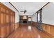 Open living room with hardwood floors, brick fireplace, and natural lighting at 1192 Princeton Kenly Rd, Kenly, NC 27542