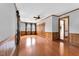 Inviting living room with hardwood floors, natural light, and timeless wood paneling at 1192 Princeton Kenly Rd, Kenly, NC 27542