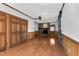 Bright living room featuring wood floors, a brick fireplace, and wood-paneled walls at 1192 Princeton Kenly Rd, Kenly, NC 27542