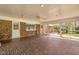 A brick sunroom featuring a tiled floor, ceiling fan, and expansive windows offering a view to the outdoor deck at 1192 Princeton Kenly Rd, Kenly, NC 27542