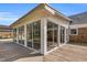 Exterior view of a sunroom with large windows and a wooden deck, blending indoor comfort with outdoor accessibility at 1192 Princeton Kenly Rd, Kenly, NC 27542