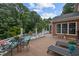 Large deck area with dining and lounging areas overlooking the yard and swimming pool at 12012 Six Forks Rd, Raleigh, NC 27614