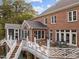 A multi-level deck offers plenty of space for entertaining with views of the lush greenery at 12012 Six Forks Rd, Raleigh, NC 27614