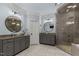 Luxurious bathroom with dual vanities, granite countertops, vessel sinks, and a large glass-enclosed shower at 12012 Six Forks Rd, Raleigh, NC 27614