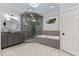 Sleek bathroom featuring a glass shower, modern vanity, and a soaking tub with stylish fixtures at 12012 Six Forks Rd, Raleigh, NC 27614