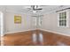 Bright, empty bedroom with hardwood floors and large windows providing plenty of natural light at 12012 Six Forks Rd, Raleigh, NC 27614