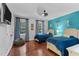 Spacious bedroom featuring two twin beds, hardwood floors and a fun accent wall at 12012 Six Forks Rd, Raleigh, NC 27614