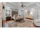 Spacious main bedroom boasts a tray ceiling, neutral tones, and decorative rug with a four-poster bed at 12012 Six Forks Rd, Raleigh, NC 27614