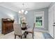 Bright breakfast nook featuring a glass table, chandelier and natural light from outdoor views at 12012 Six Forks Rd, Raleigh, NC 27614