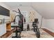 Bright workout room featuring a multi-gym, exercise bike, and hardwood floors at 12012 Six Forks Rd, Raleigh, NC 27614