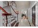 Bright foyer featuring a staircase with rich wood accents and an entryway with marble tiled floor and views to dining area at 12012 Six Forks Rd, Raleigh, NC 27614