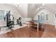 Recreation room with hardwood floors, ping pong table, exercise equipment, and bright natural light at 12012 Six Forks Rd, Raleigh, NC 27614